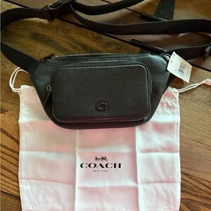 Coach belt bag with signature canvas interior.
